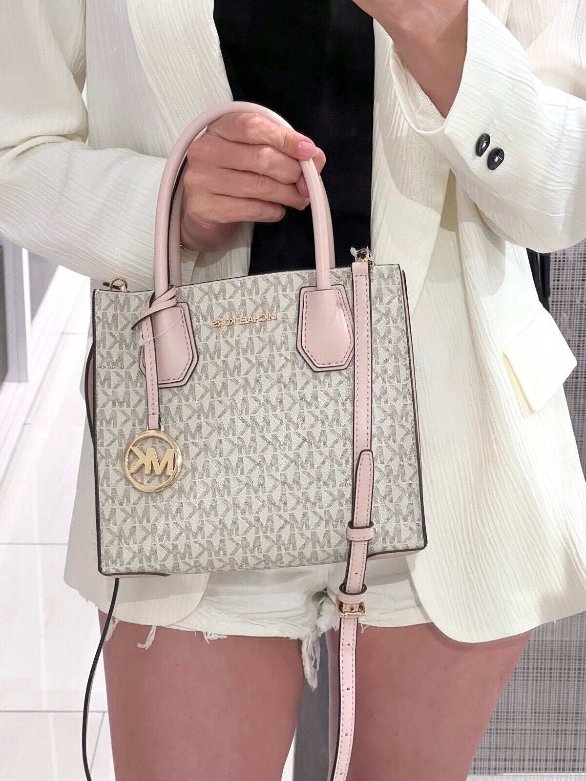 Michael Kors Mercer Messenger Medium Crossbody Bag in Vanilla Powder Blush with gold-tone hardware and logo.