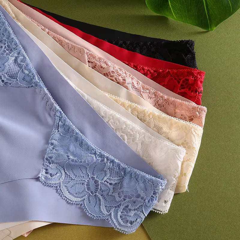 Colorful lace-trimmed women's sexy underwear set displayed on a green background.