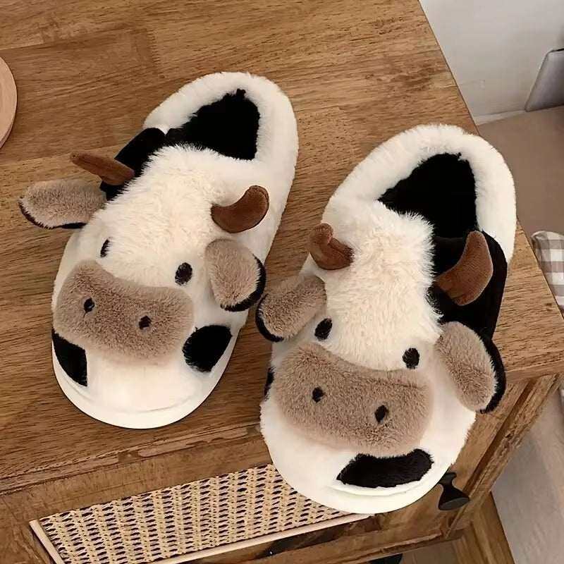 Women's fuzzy house slippers with cozy cow design, closed toe, and slip-on style for indoor comfort.