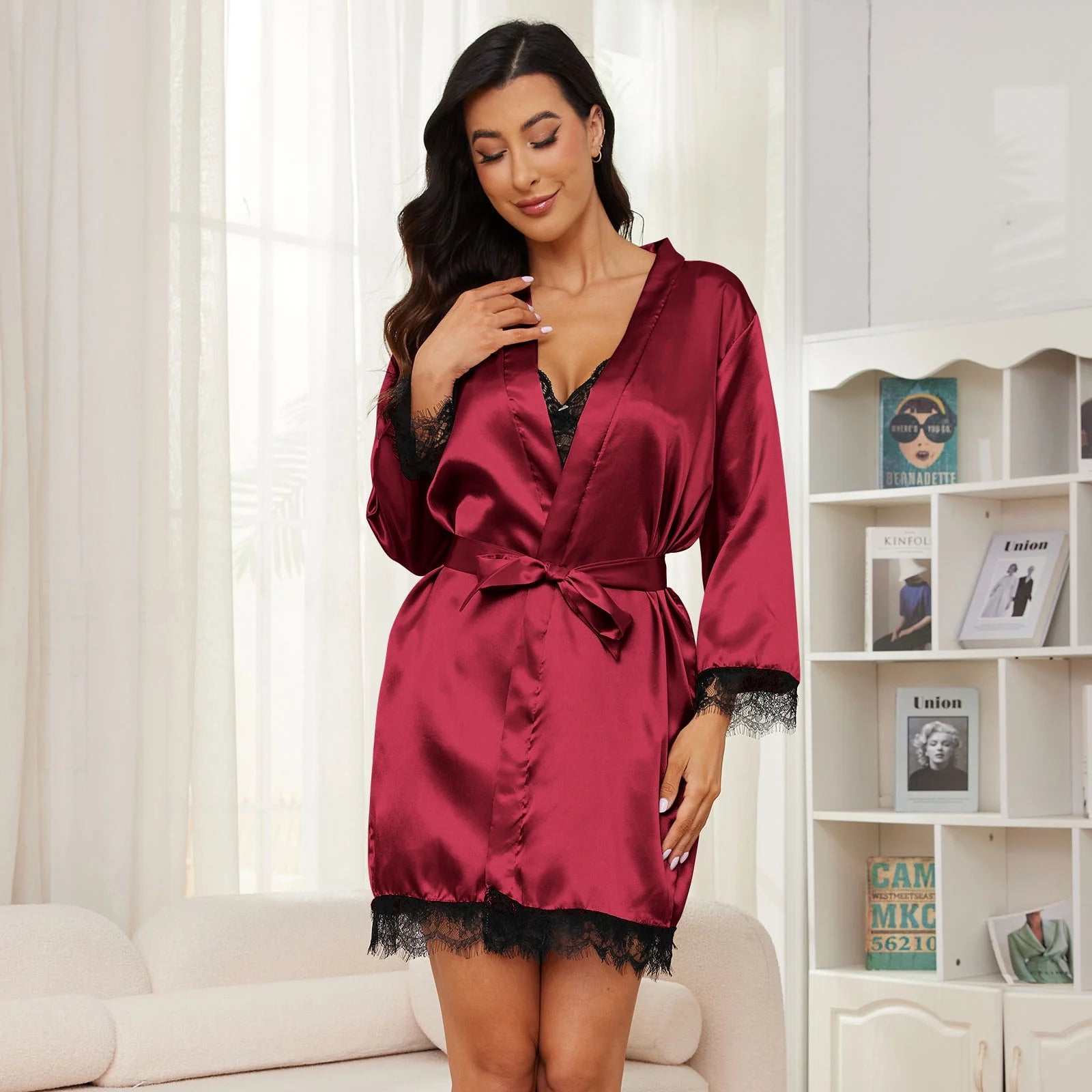 Silk satin pajamas set for women with a lace-trimmed robe in burgundy, featuring an adjustable waist belt, ideal for versatile occasions.