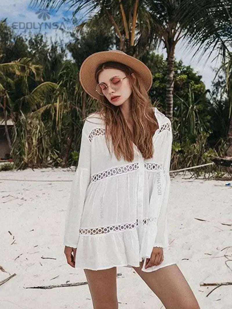 White swimsuit cover-up tunic dress with lace details, perfect for beach outings.