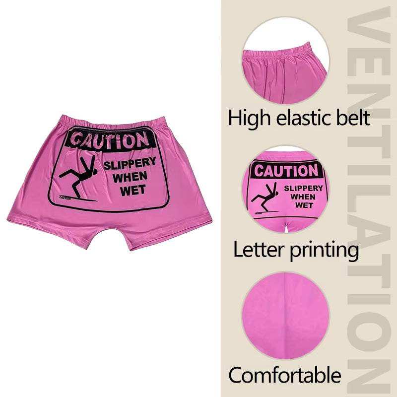 Cozy pink pajama boxer bottoms with "Caution Slippery When Wet" print and high elastic belt.