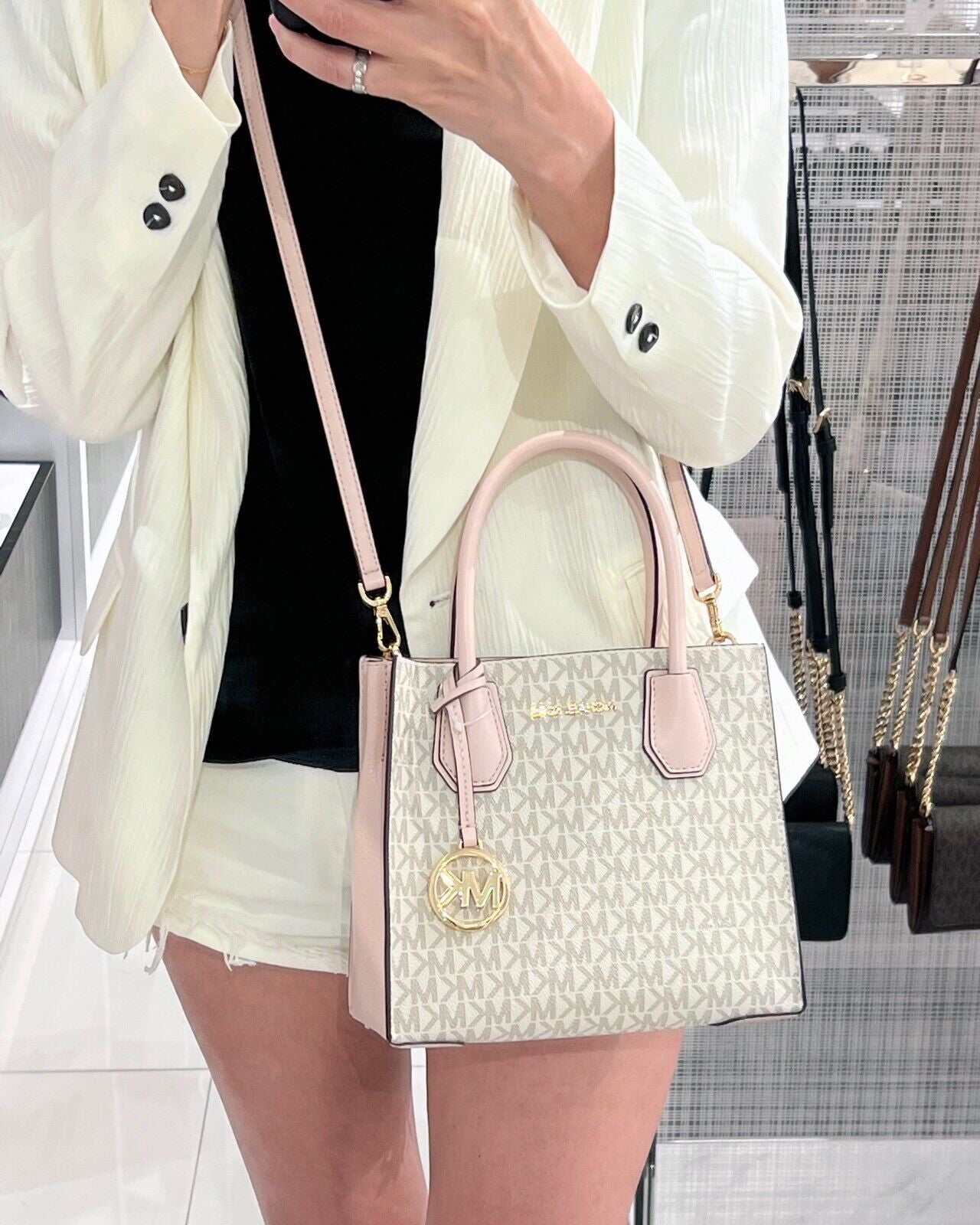 Michael Kors Mercer Messenger Medium Crossbody Bag in Vanilla Powder Blush with gold-tone hardware.