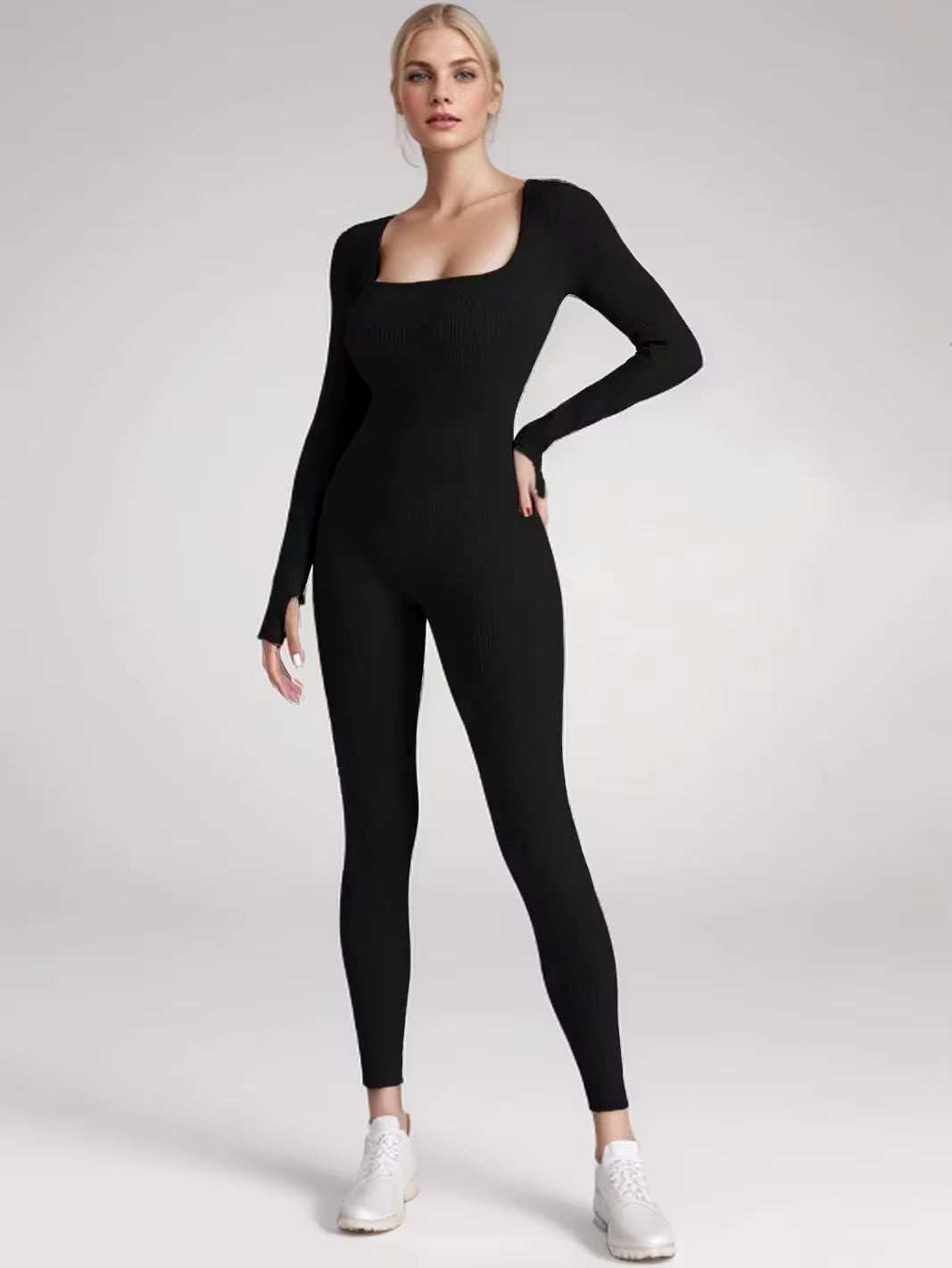 Women's long sleeve black jumpsuit for yoga and exercise.