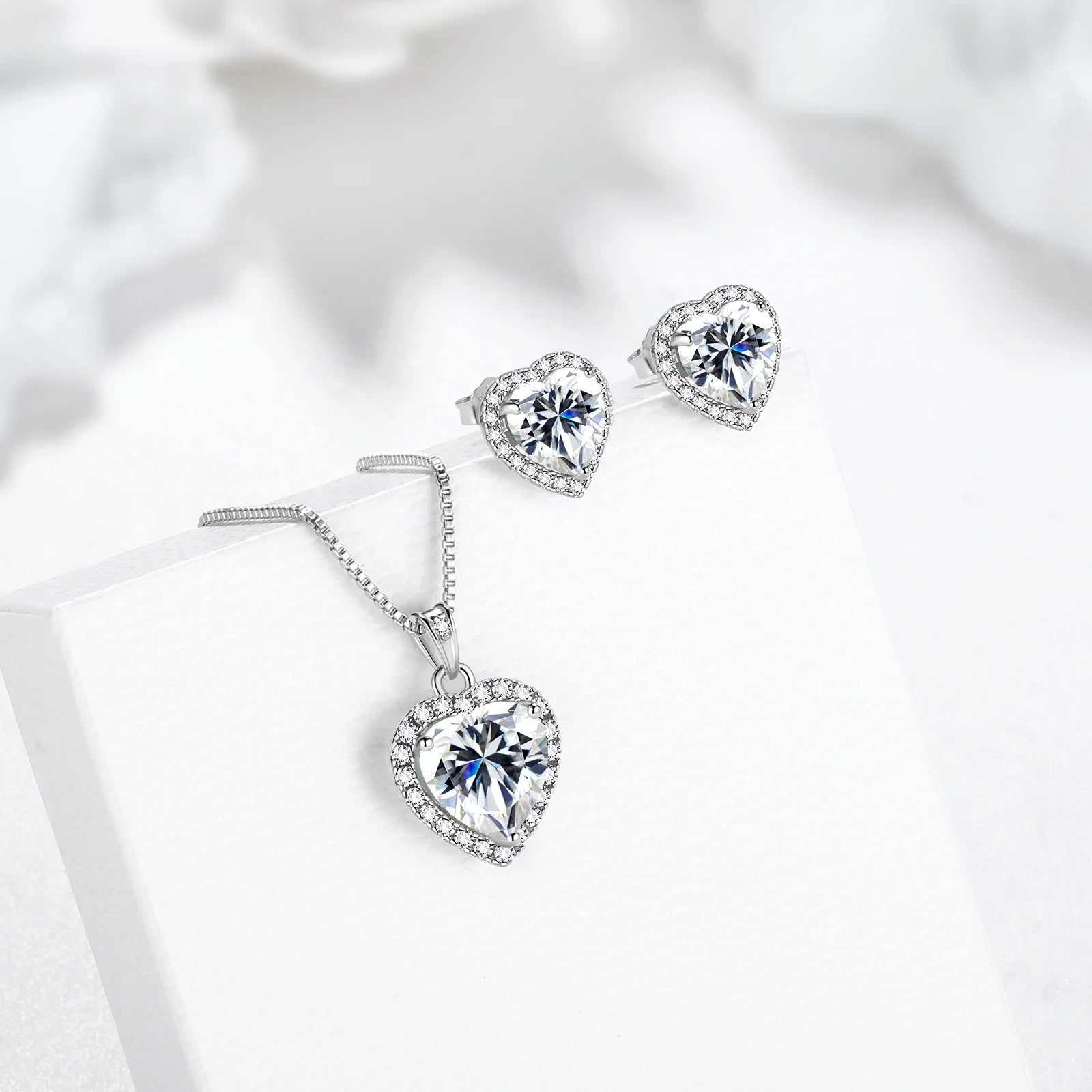 Sterling silver heart-shaped birthstone jewelry set with earrings and necklace.