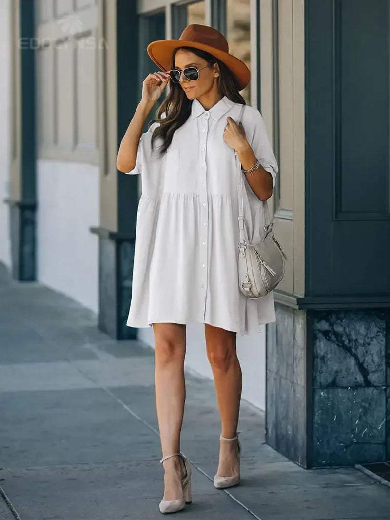 Women white tunic dress beach cover-up with mandarin sleeves, styled with sunglasses and a hat.