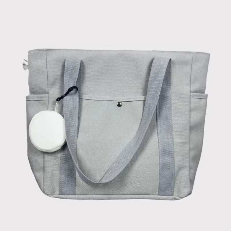 Large gray canvas shoulder tote bag with spacious design and sturdy straps.