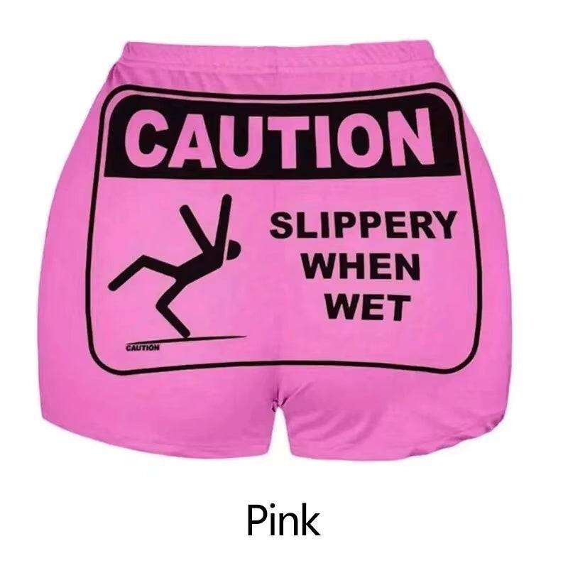 Soft pink pajama boxer bottoms with "Caution: Slippery When Wet" print.