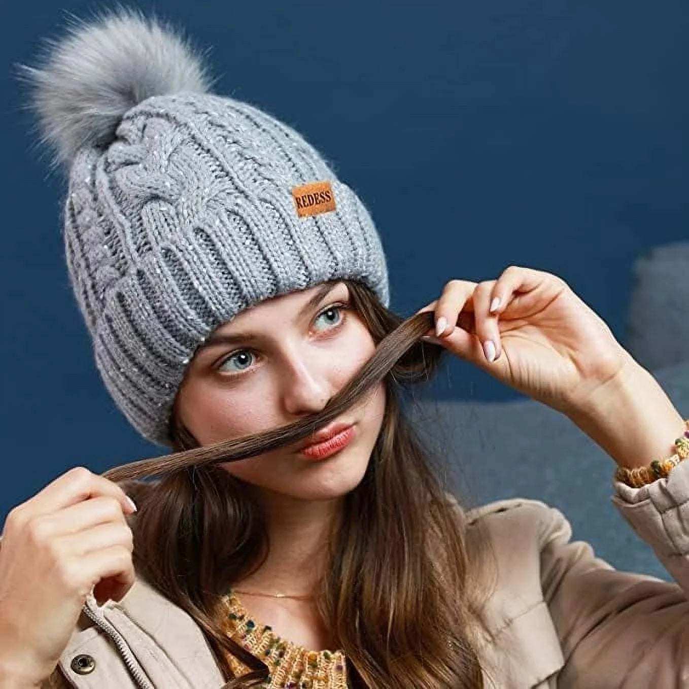 Cute pink women winter hat with fleece lining and pompom, stylish and warm knit ski cap.