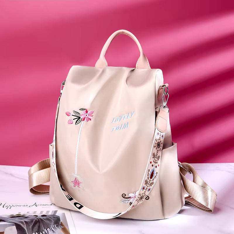 Fashionable women's backpack with embroidery, anti-theft design, and waterproof Oxford canvas material.