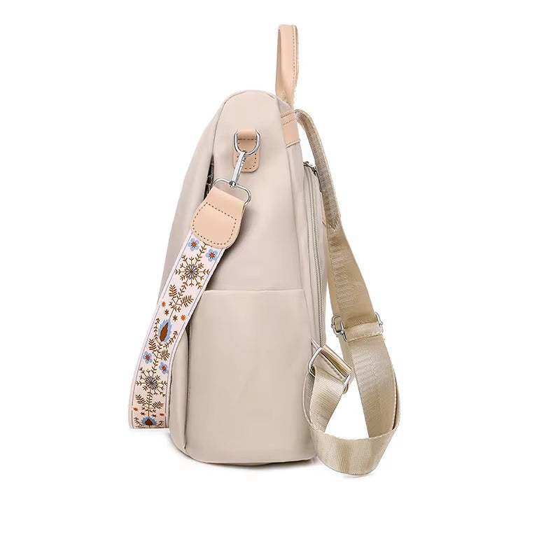 Fashionable women’s backpack with embroidery, anti-theft features, and durable canvas material.