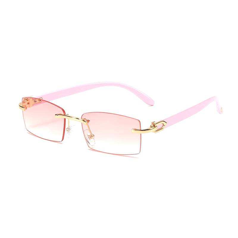 Sunglasses Rimless Rimless horn sunglasses with pink lenses and gold detailing.