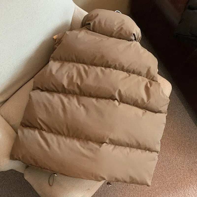 Thick brown windproof down vest coat on a chair, showcasing warm and stylish winter outerwear.