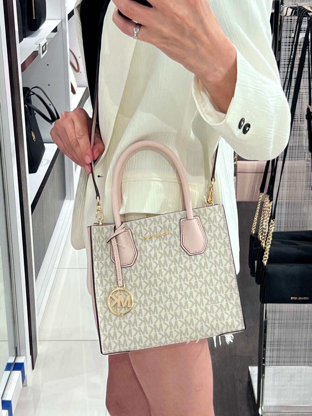 Michael Kors Mercer Messenger Medium Crossbody Bag in Vanilla Powder Blush with gold-tone hardware.