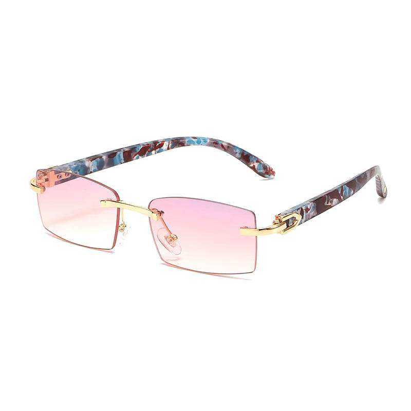 Sunglasses Rimless Rimless horn sunglasses with pink tinted lenses and patterned temples.