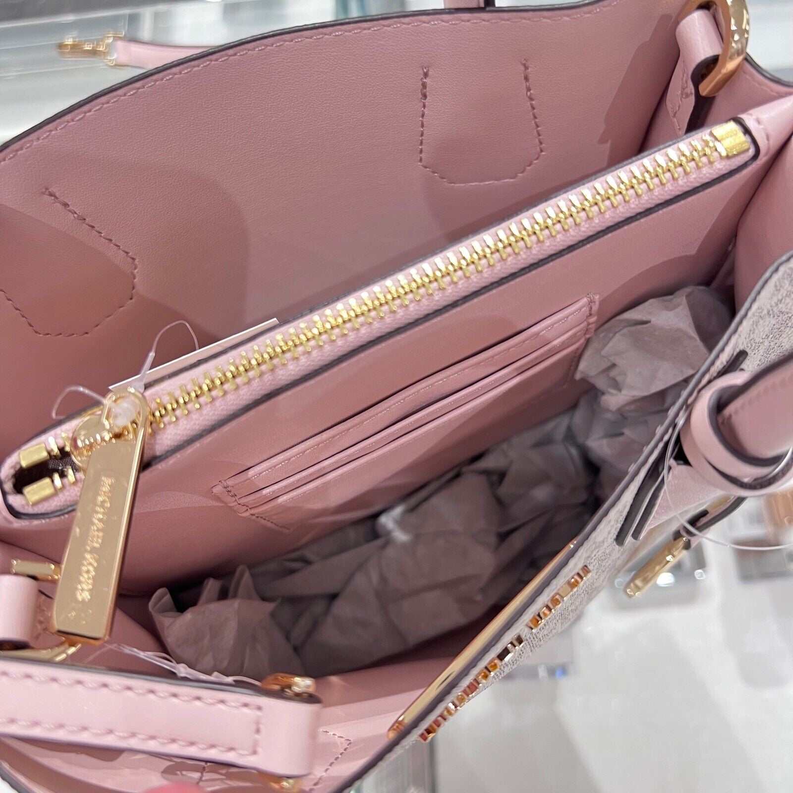 Michael Kors Mercer Messenger Medium Crossbody Bag in Vanilla Powder Blush with gold-tone hardware and multiple compartments.