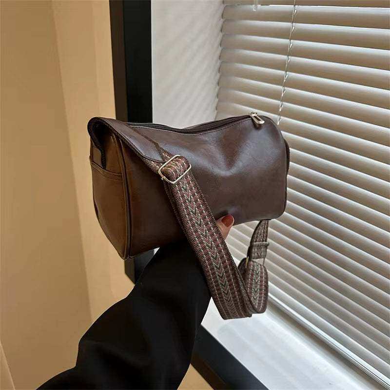 Vintage leather Boston women's small crossbody bag with adjustable strap.